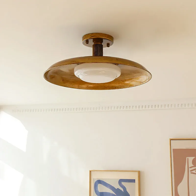 American retro alloy ceiling lamp in copper finish mounted on a ceiling.