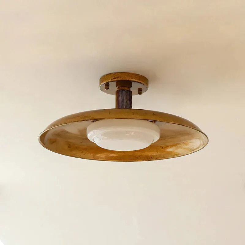 American retro alloy ceiling lamp in copper finish mounted on a ceiling.