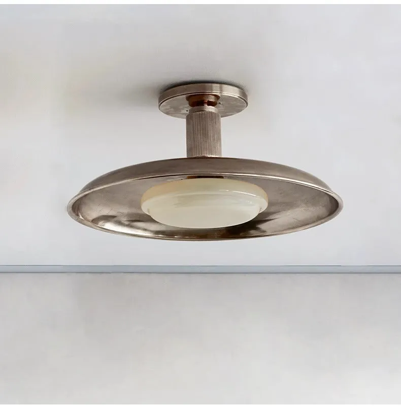 American retro alloy ceiling lamp in copper finish mounted on a ceiling.