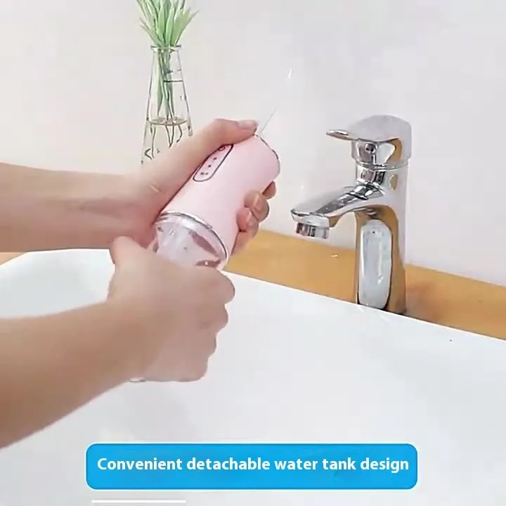 Pink electric water flosser with 300ml tank, multiple nozzles, and IPX7 waterproof design