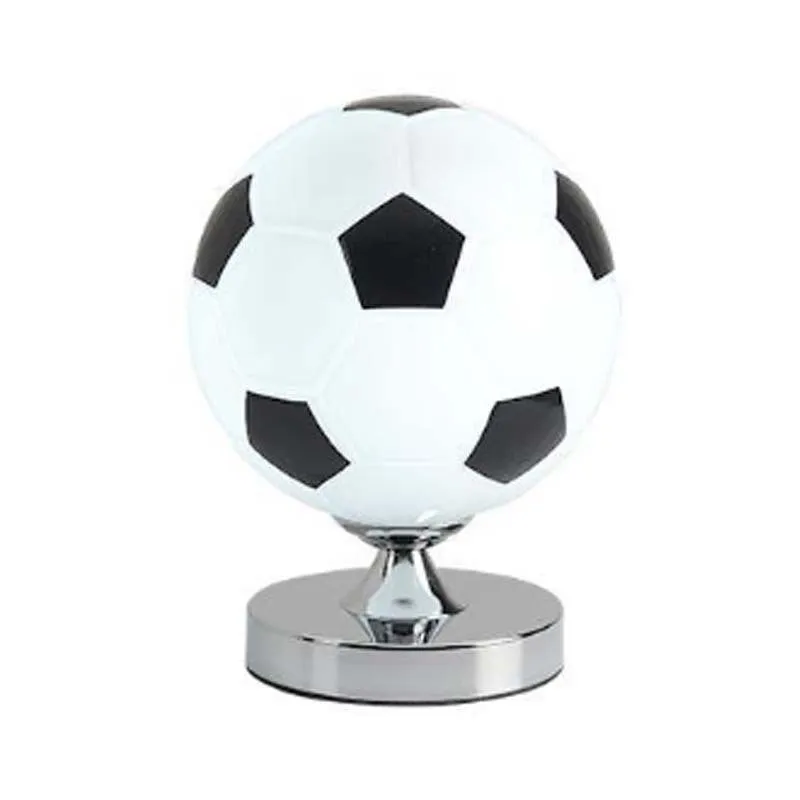 Creative football-shaped glass table lamp with dimmer switch on a desk in a modern living room