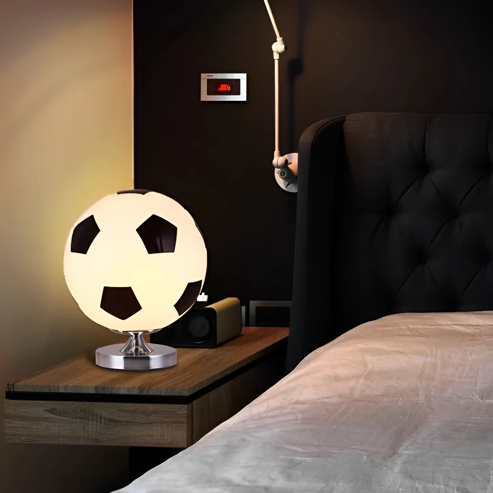 Creative football-shaped glass table lamp with dimmer switch on a desk in a modern living room