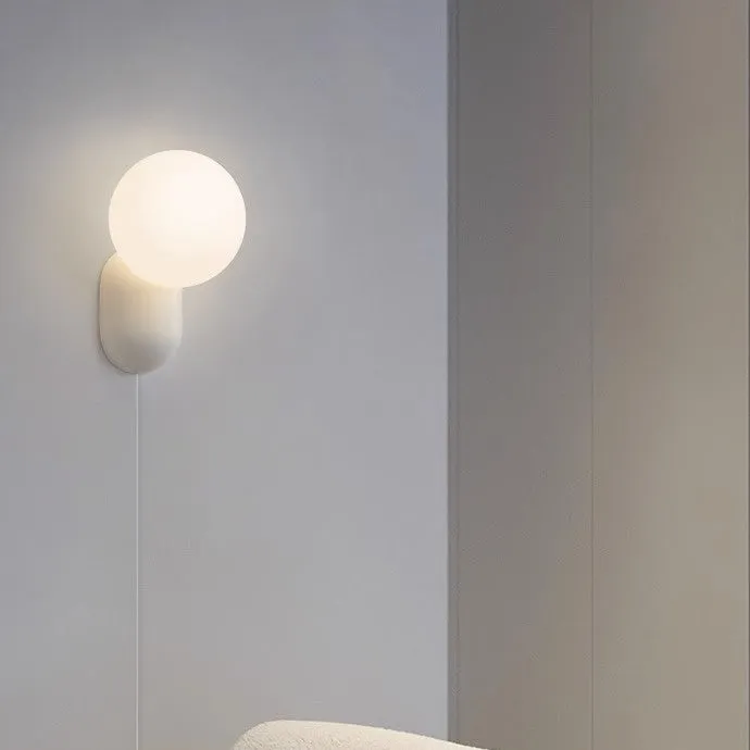 Nordic bedside wall lamp in black with acrylic shade and resin body