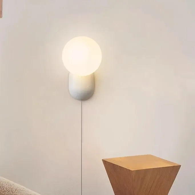 Nordic bedside wall lamp in black with acrylic shade and resin body