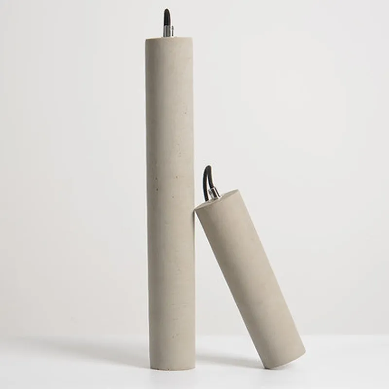 Cement industrial droplight in glossy finish on a wooden bedside table