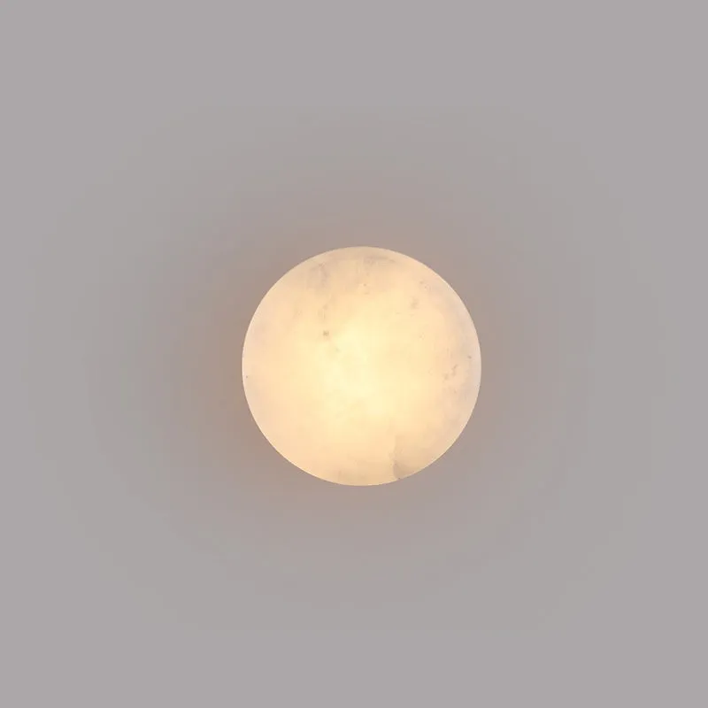 Spanish natural marble round wall lamp with warm light, 130mm diameter, black finish on a bedroom wall