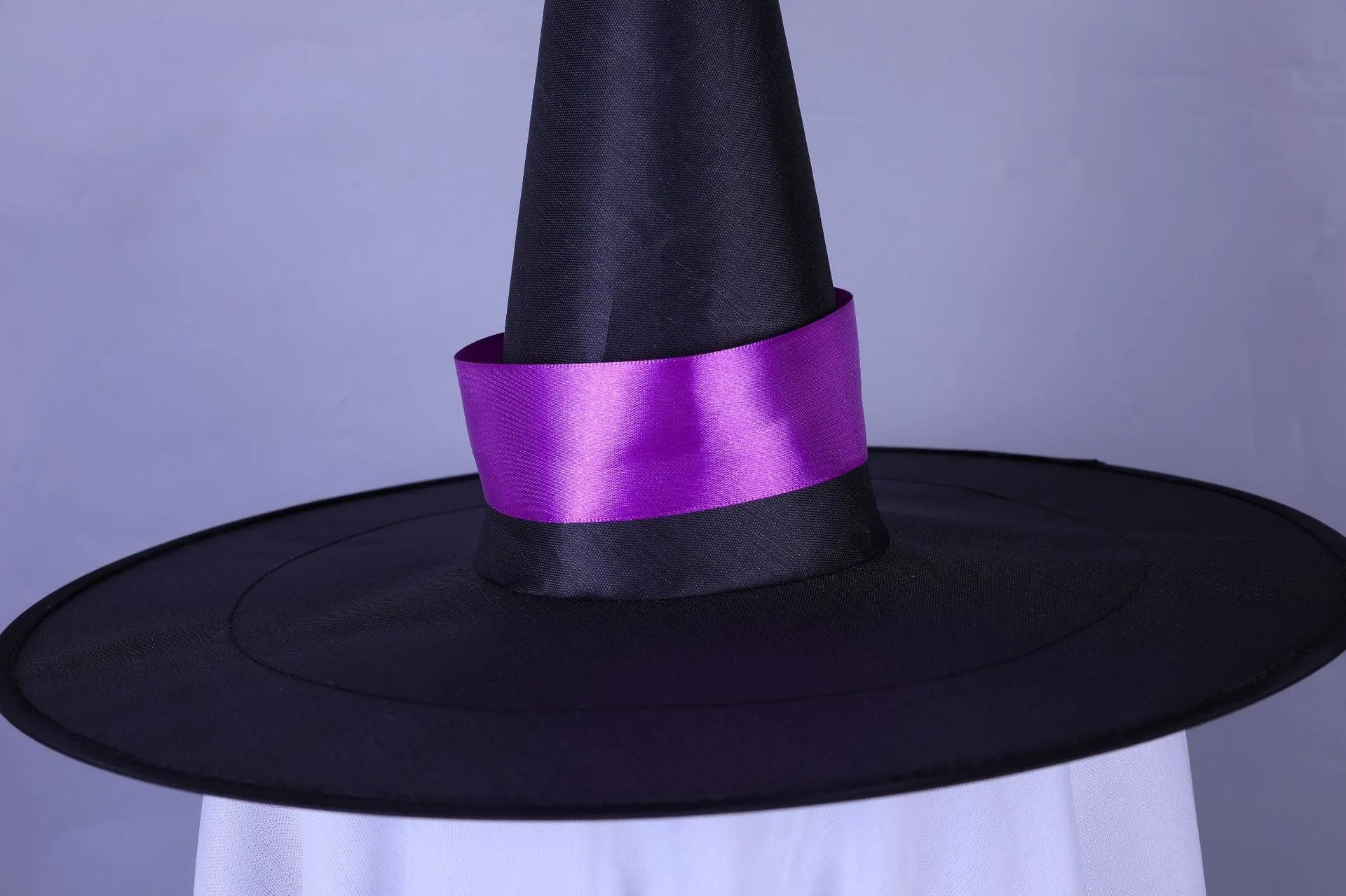 White Halloween wizard hat and ghost LED light string pendant hung indoors