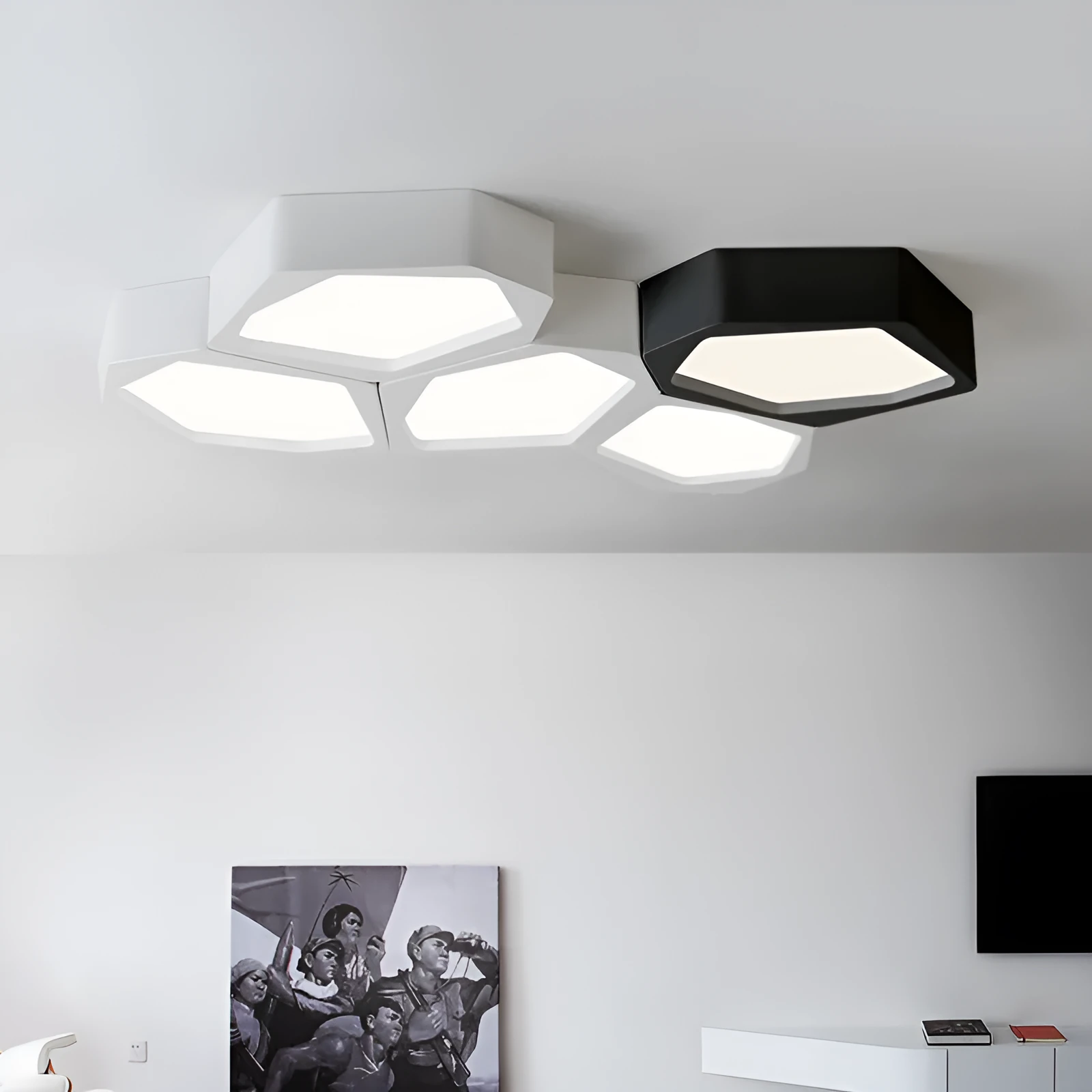 Geometric shaped iron LED light with black frame and remote control on a table.