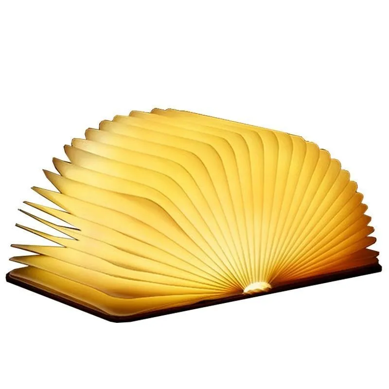 Leather folding night lamp in tricolour lighting on a wooden surface, size small book 10x8x2.5cm