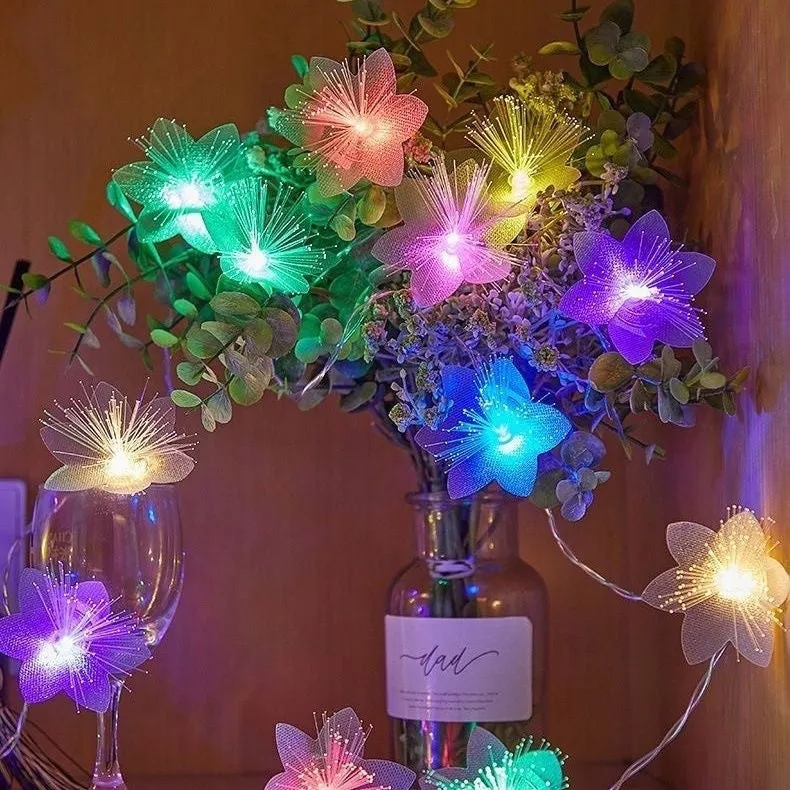 LED optical fibre flower light string with battery box, 20 warm white beads on a dark background
