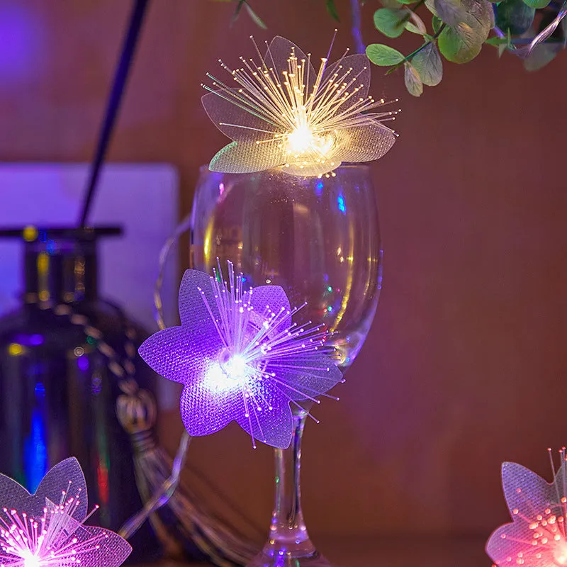LED optical fibre flower light string with battery box, 20 warm white beads on a dark background