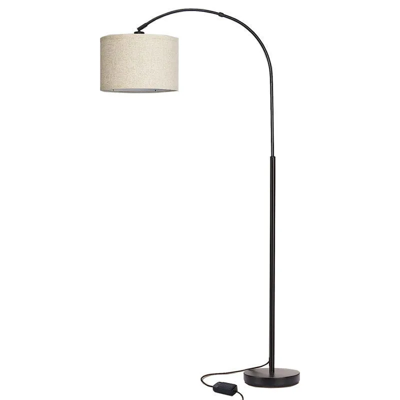 Modern minimalist fishing floor lamp with black fabric shade standing in a living room corner