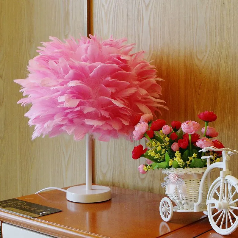 White handmade feather table lamp with metal base on a wooden desk, remote control visible, 30cm diameter