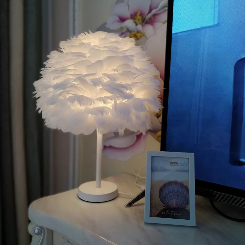 White handmade feather table lamp with metal base on a wooden desk, remote control visible, 30cm diameter