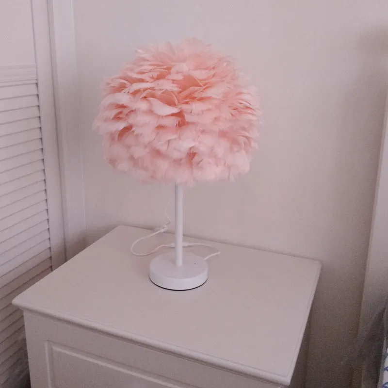 White handmade feather table lamp with metal base on a wooden desk, remote control visible, 30cm diameter