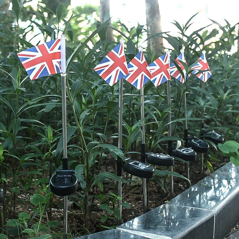 Solar-powered stainless steel garden flag light showing American flag design with white LEDs illuminated.
