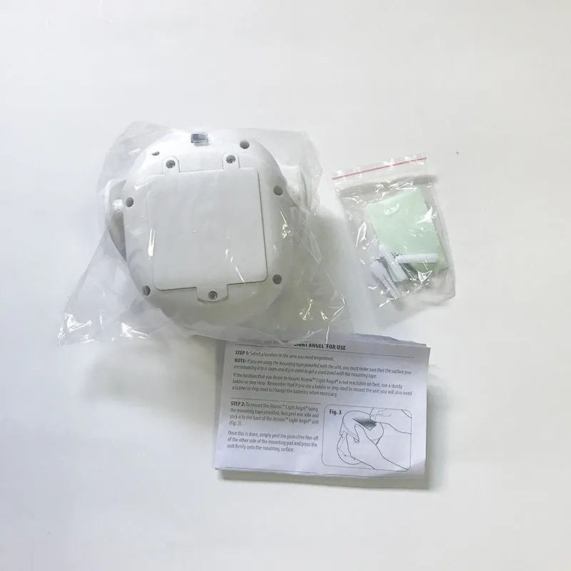 White Atomic Angel induction lamp with compact ABS housing on charging base.