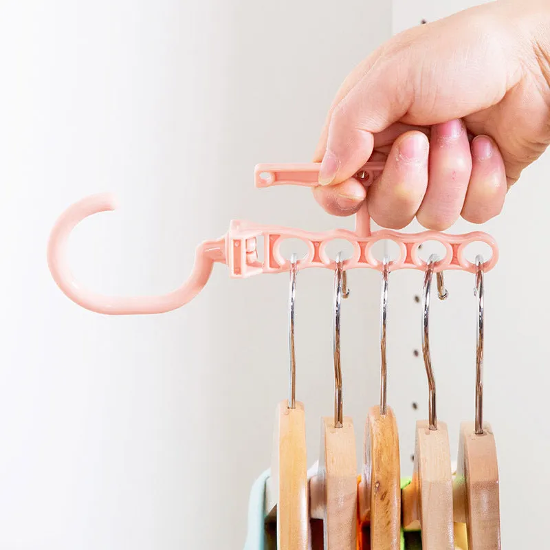 Blue revolving wardrobe hanger with five holes and handle for organising multiple garments