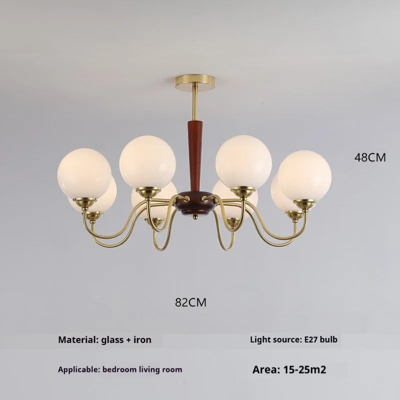 American retro persimmon chandelier with amber yellow glass shades in a dining room setting