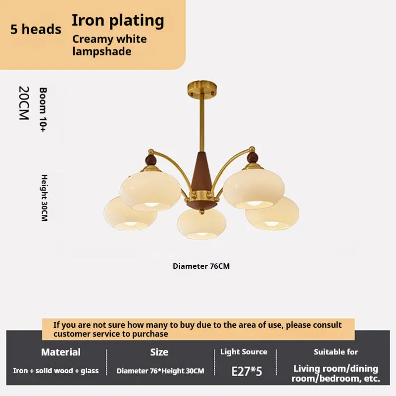 American retro persimmon chandelier with amber yellow glass shades in a dining room setting