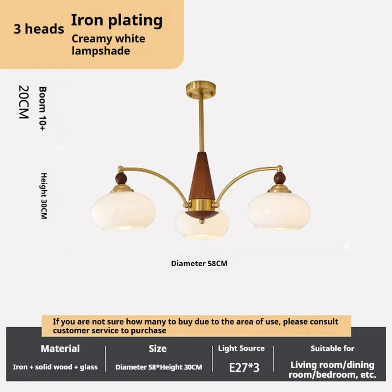 American retro persimmon chandelier with amber yellow glass shades in a dining room setting