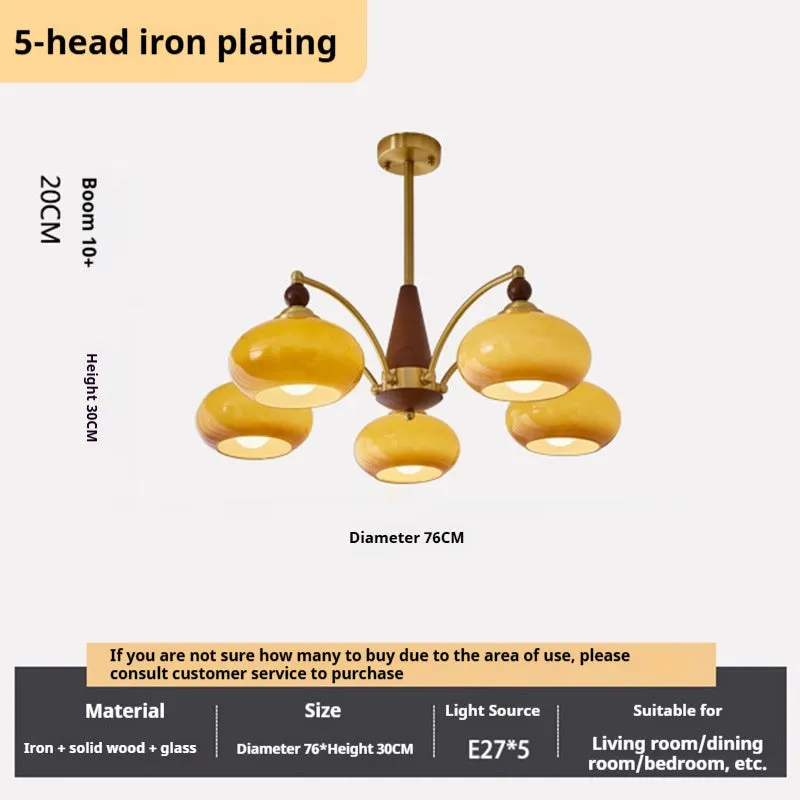 American retro persimmon chandelier with amber yellow glass shades in a dining room setting