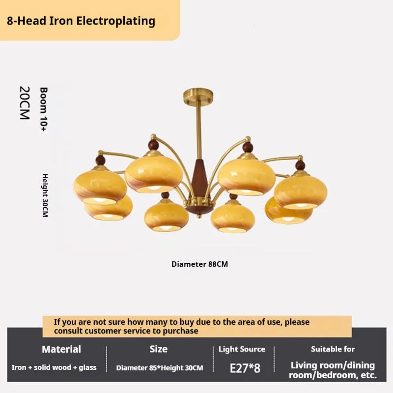 American retro persimmon chandelier with amber yellow glass shades in a dining room setting