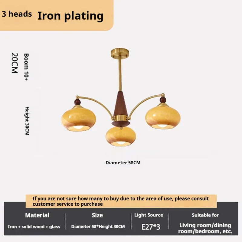 American retro persimmon chandelier with amber yellow glass shades in a dining room setting