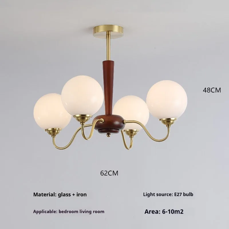 American retro persimmon chandelier with amber yellow glass shades in a dining room setting