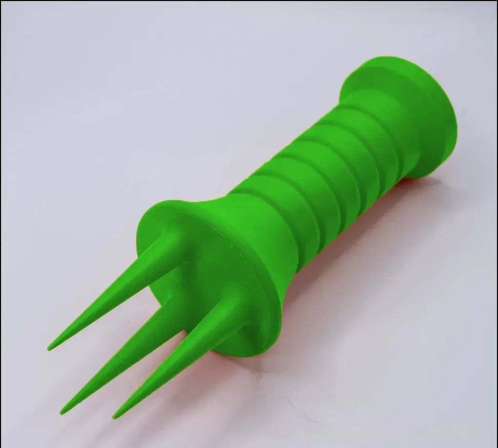 Home gardening soil aerator plastic hand tool in orange, 3.3cm x 10cm size, on soil