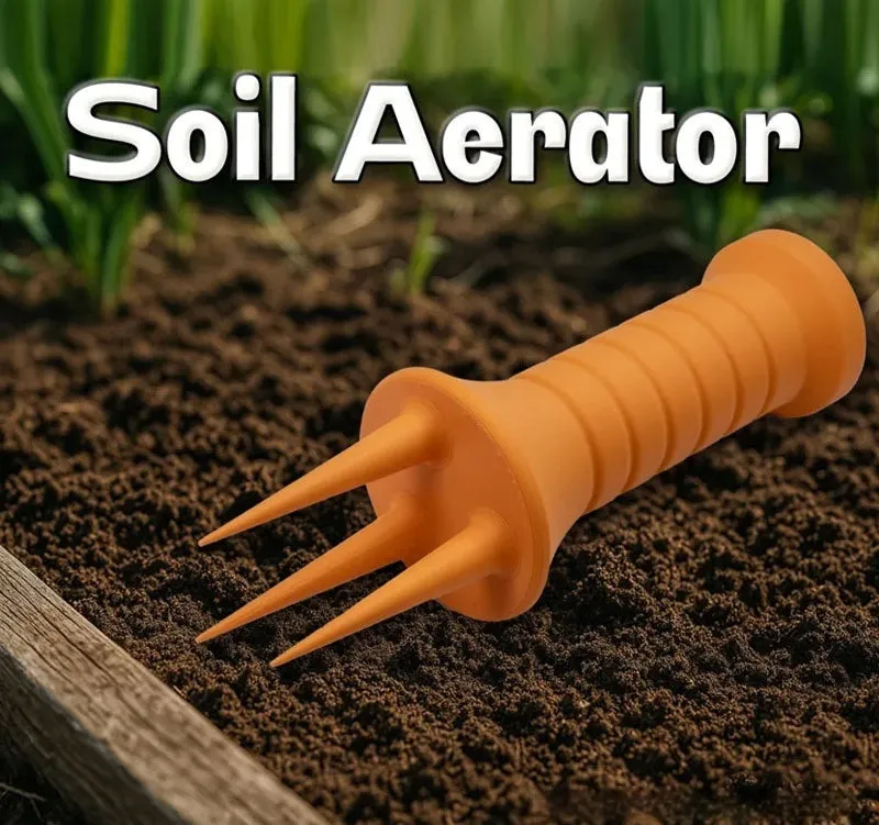 Home gardening soil aerator plastic hand tool in orange, 3.3cm x 10cm size, on soil