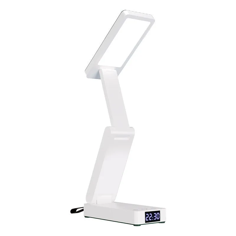 White table lamp with charging function, clock, and power bank on a desk