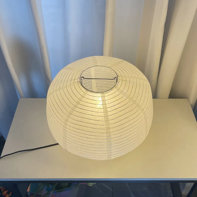 Japanese style xuan paper desk lamp with three-colour light source on a wooden desk in a bedroom