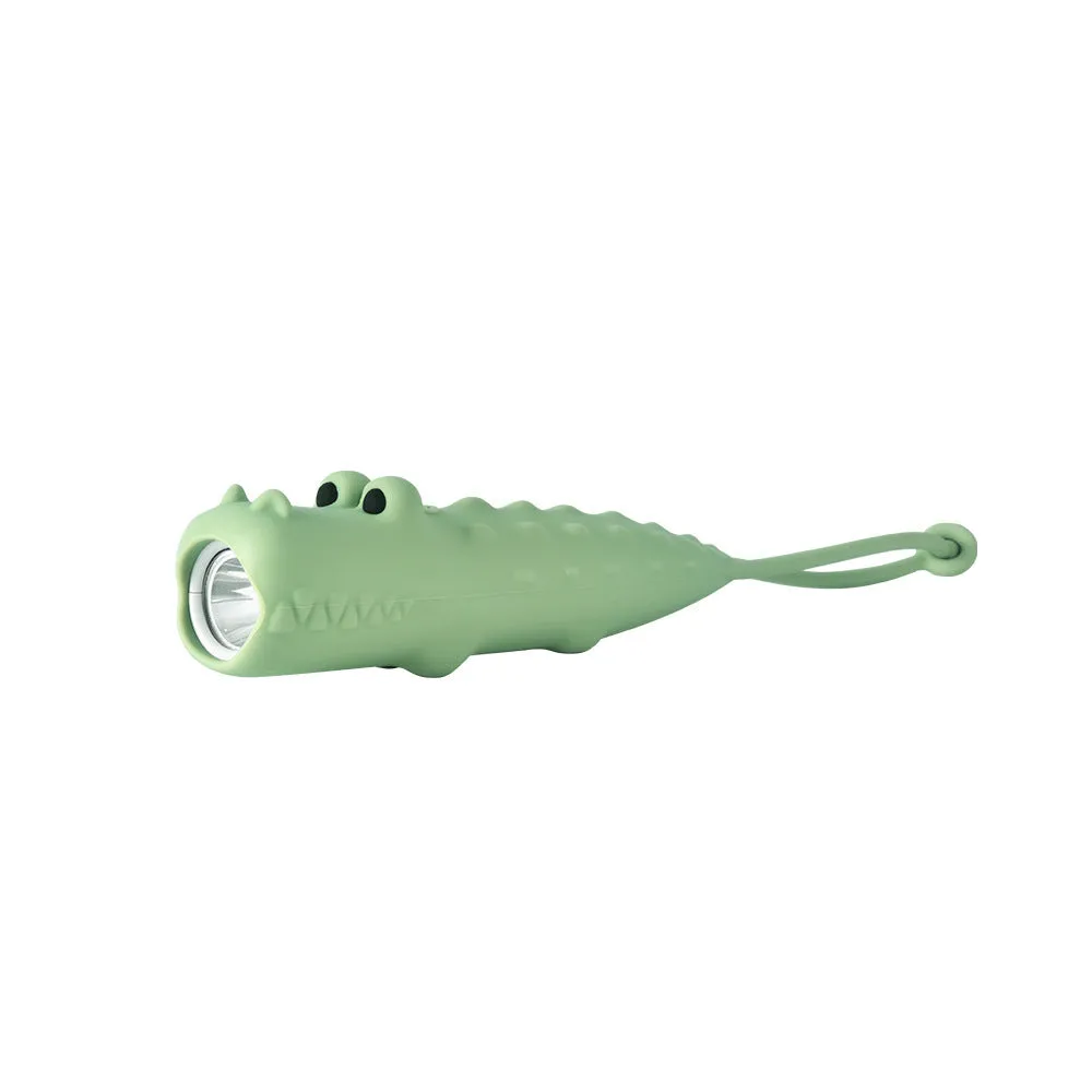 Four silicone animal toy flashlights in Blue Shark, Brown Lion, Brown Puppy, and Green Crocodile designs