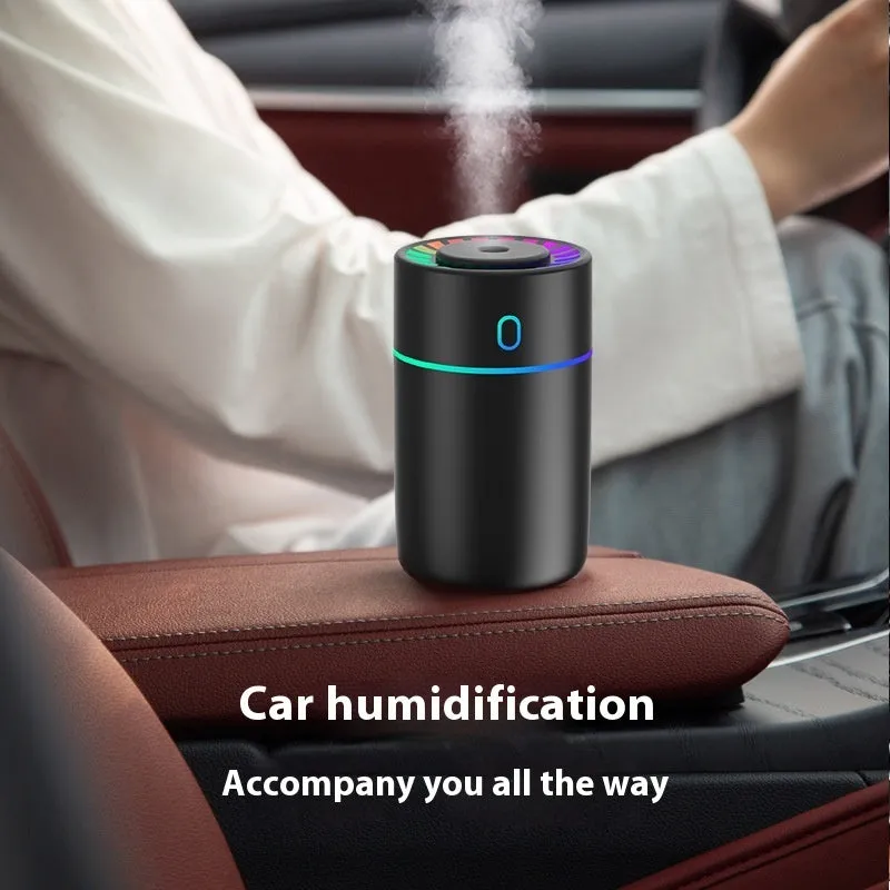Round plastic USB desktop humidifier in black, pink, and white with single fog outlet