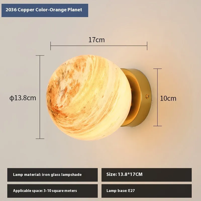 Planet Aisle bedside lamp with painted glass shade in black blue planet colour, on a table