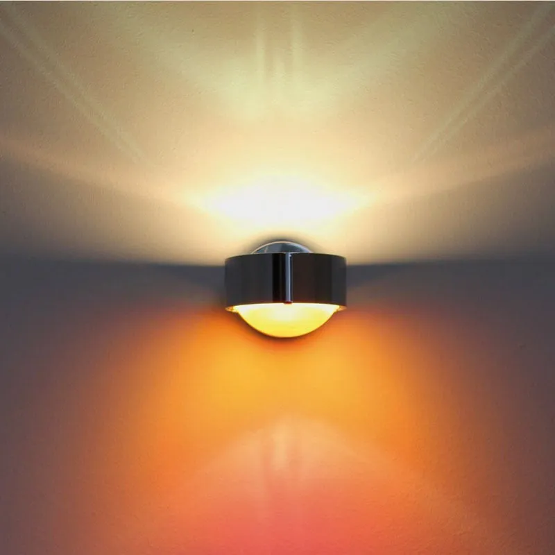Modern small wall lamp in chrome finish for bedside or hallway lighting