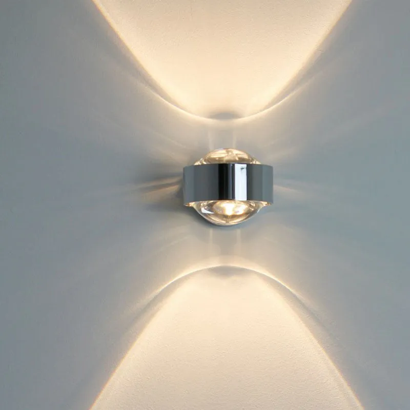 Modern small wall lamp in chrome finish for bedside or hallway lighting