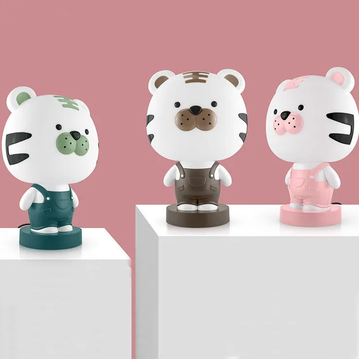 Cartoon animal table lamp in plastic, available as a bear, cow, rabbit, or tiger design.