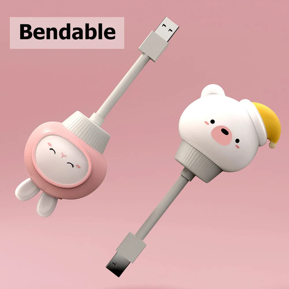Cute cartoon animal USB night light in bear shape with soft white glow on a bedside table.