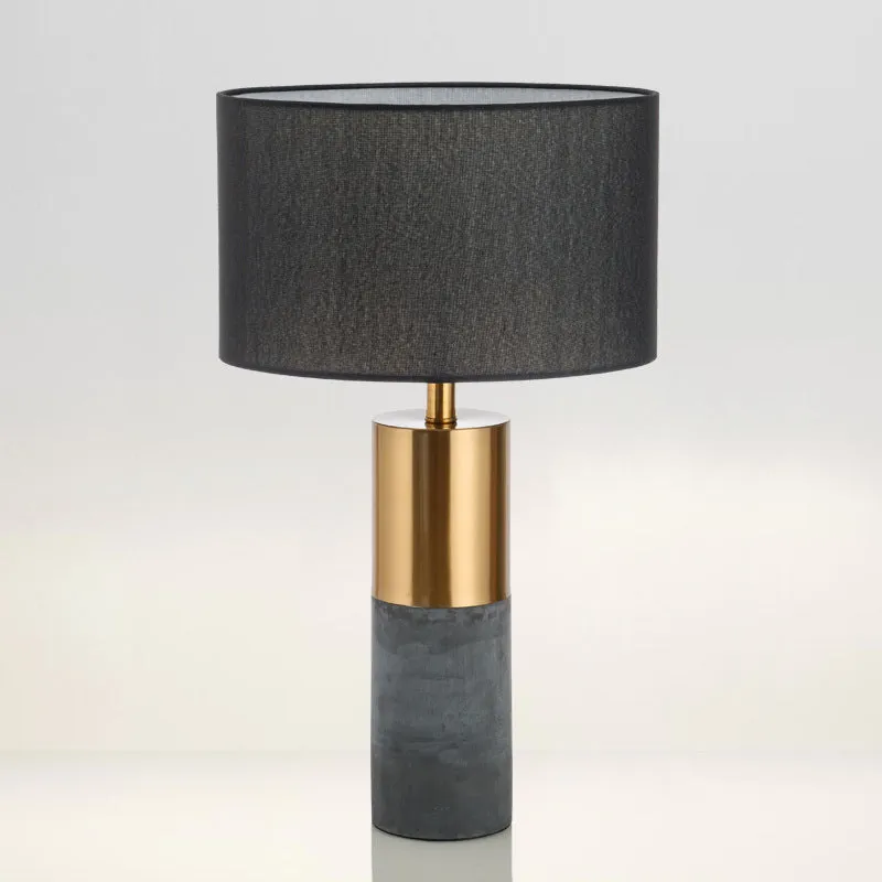 Simple designer industrial style table lamp in dark gray on a wooden desk with ambient lighting