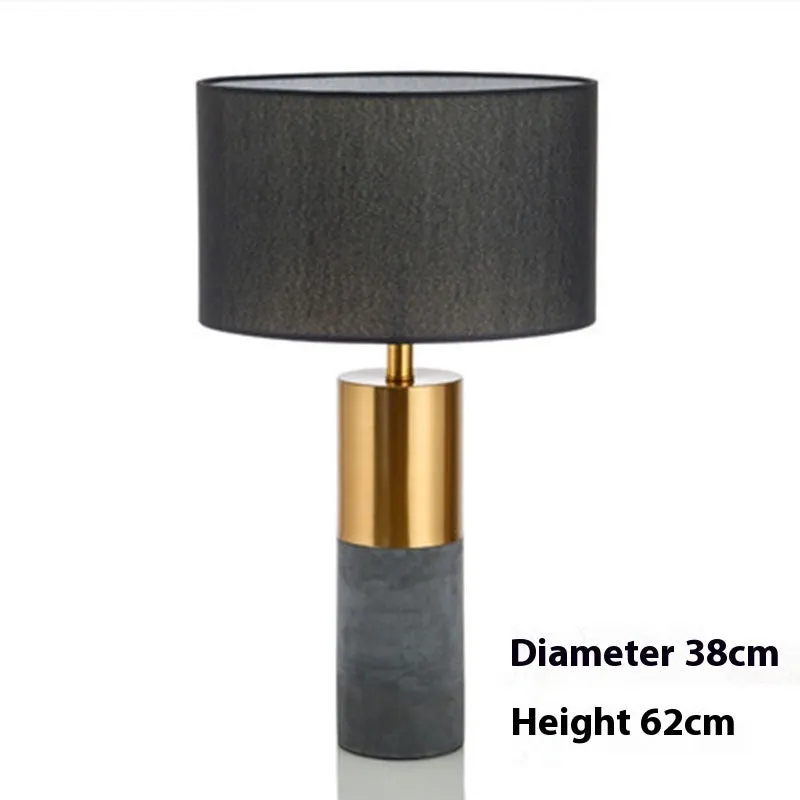 Simple designer industrial style table lamp in dark gray on a wooden desk with ambient lighting