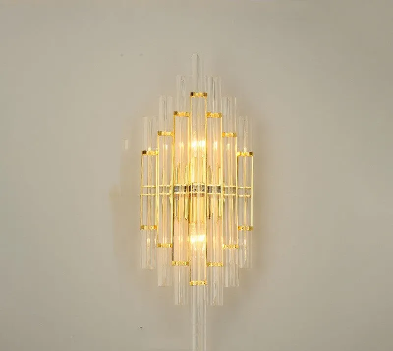 Modern crystal petal wall lamp with metallic gold finish mounted on a light-coloured wall.