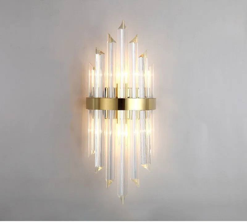 Modern crystal petal wall lamp with metallic gold finish mounted on a light-coloured wall.