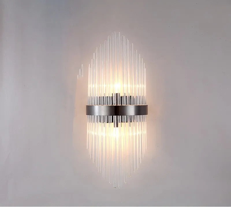 Modern crystal petal wall lamp with metallic gold finish mounted on a light-coloured wall.