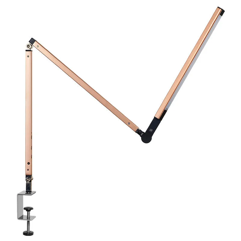 Adjustable LED desk lamp with clip attachment in black finish on wooden desk