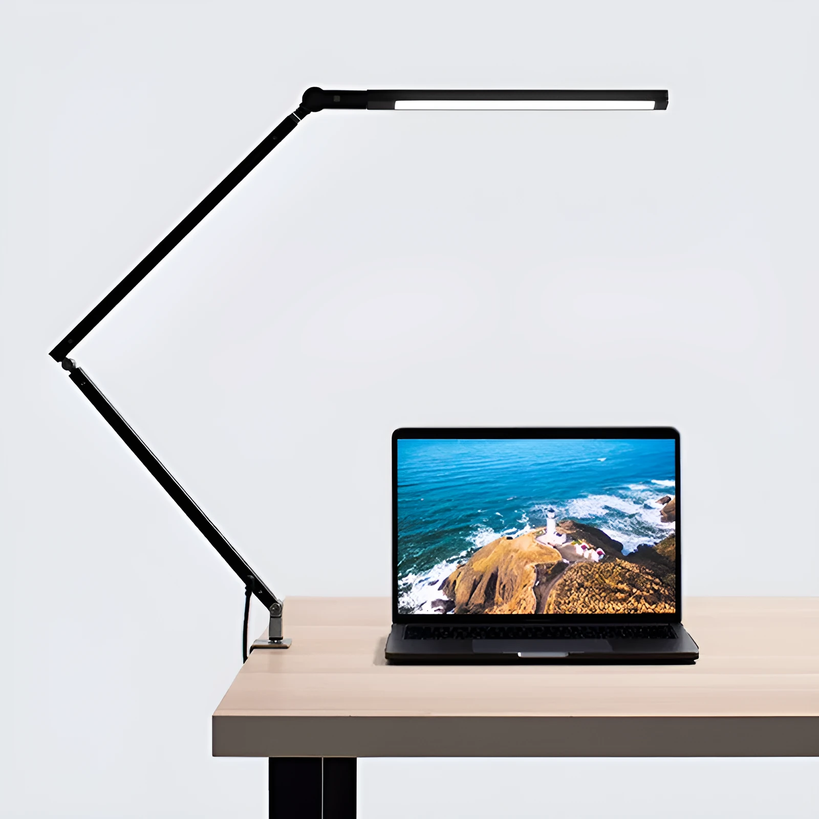 Adjustable LED desk lamp with clip attachment in black finish on wooden desk