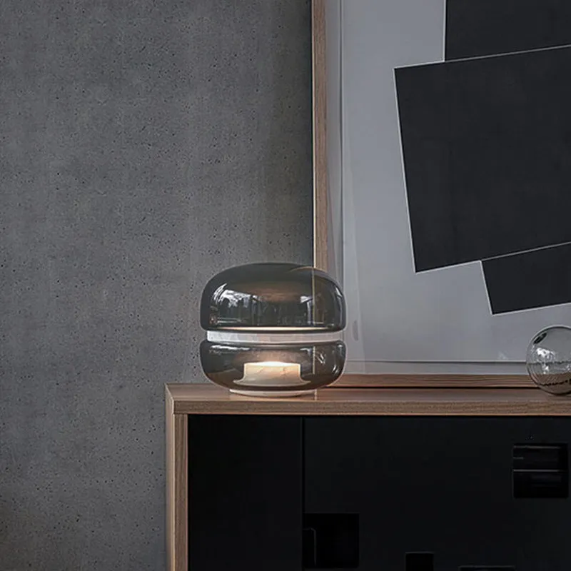 Nordic modern creative table lamp with warm light on a desk