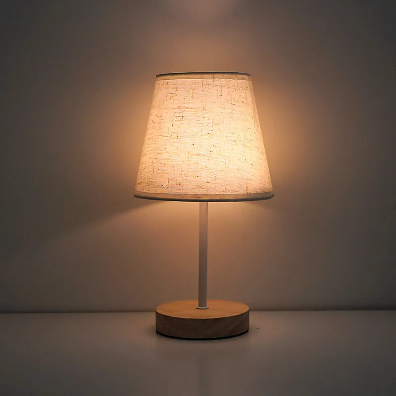 Solid wood fabric bedside lamp with rechargeable touch dimming and three colour light options on a nightstand