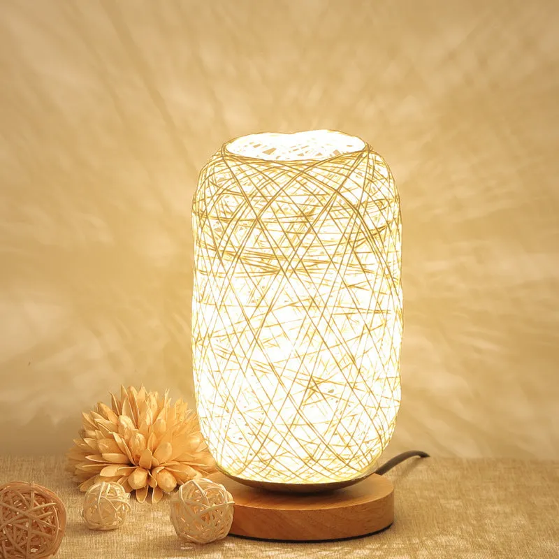 Brown hemp rope sphere desk lamp with wooden base on a desk